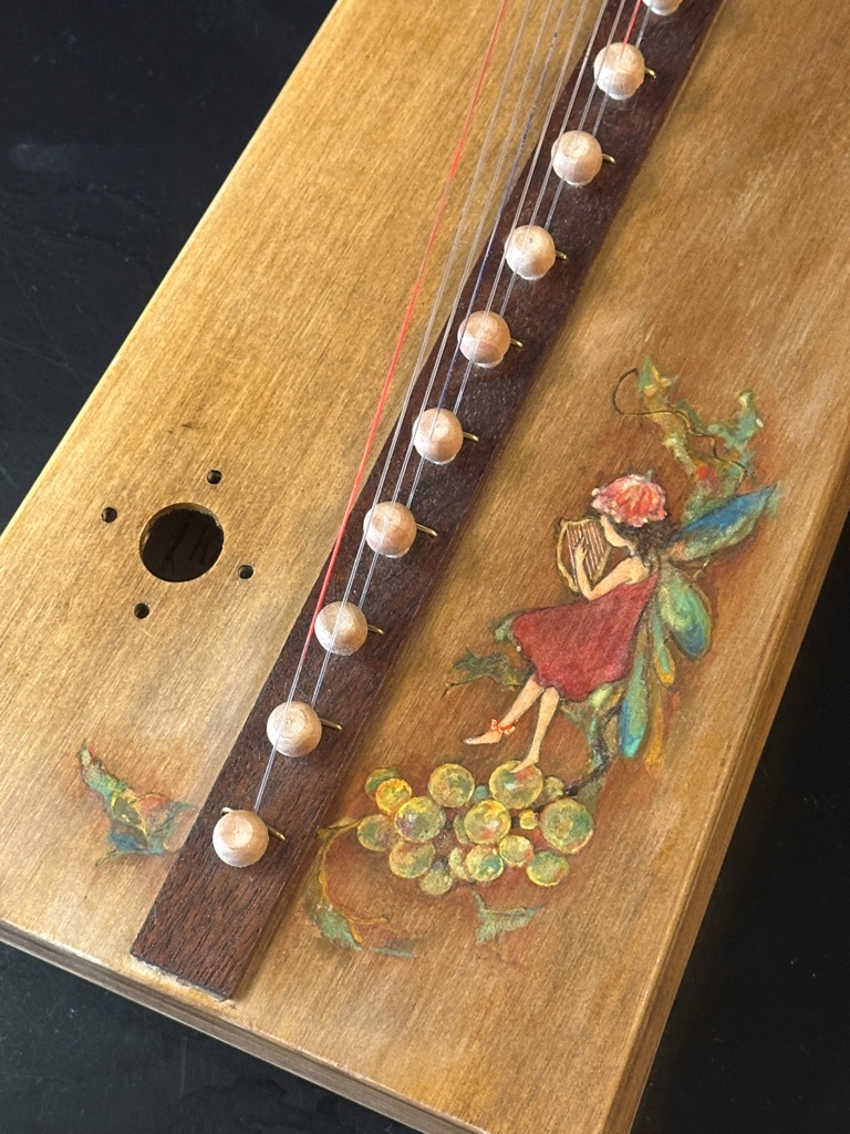 妖精と葡萄が描かれたハープ